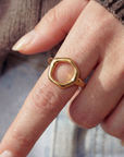 Gold ring on a finger with a blurred background