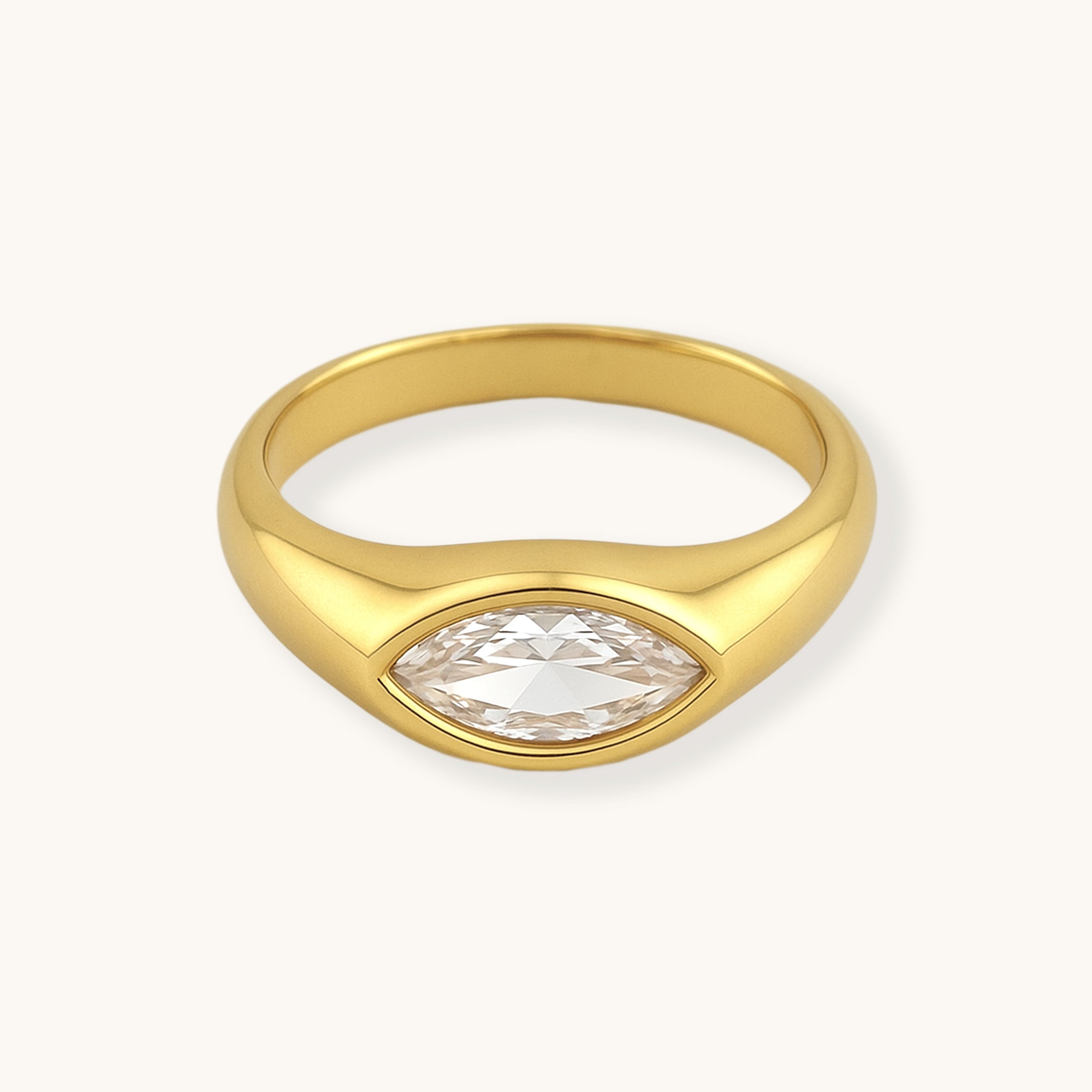 Gold ring with a clear gemstone on a white background