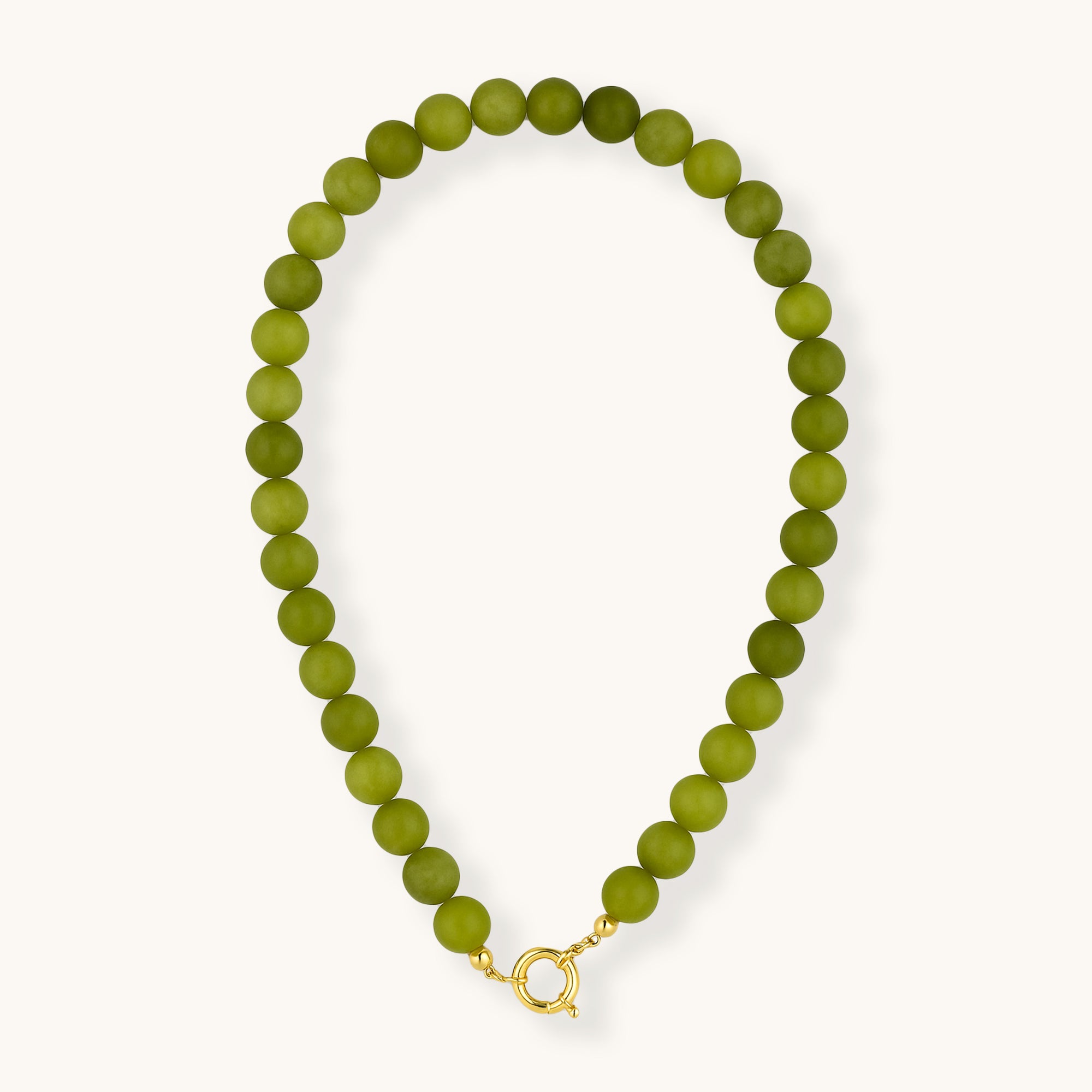 Green beaded necklace with a gold clasp on a white background