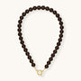 Beaded necklace with gold clasp on a white background