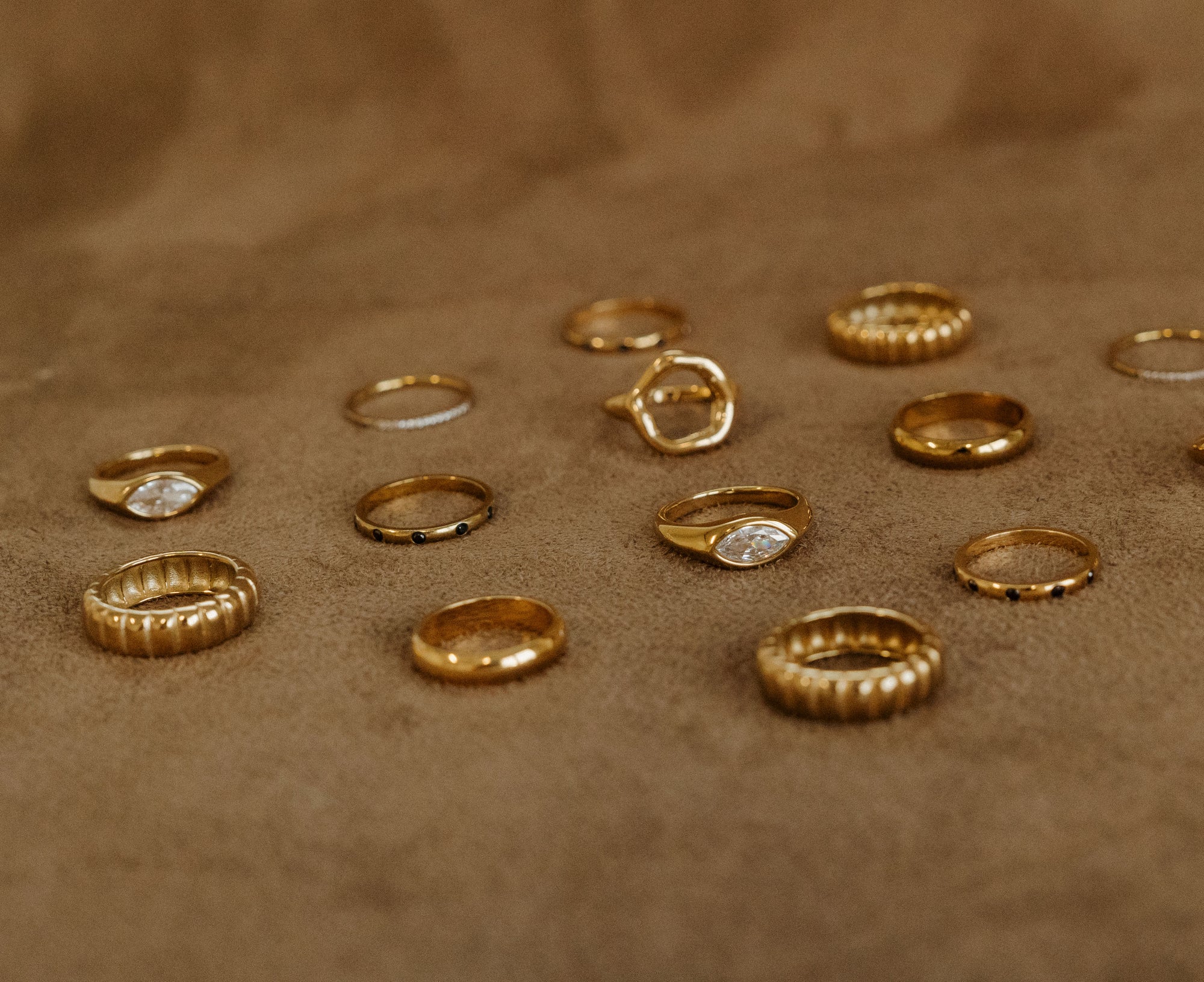 Gold rings on a brown fabric background