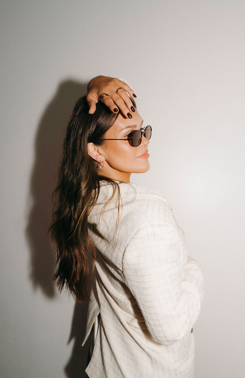 Woman wearing sunglasses with a plain background