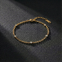 Gold bracelet with small diamonds on a dark textured surface
