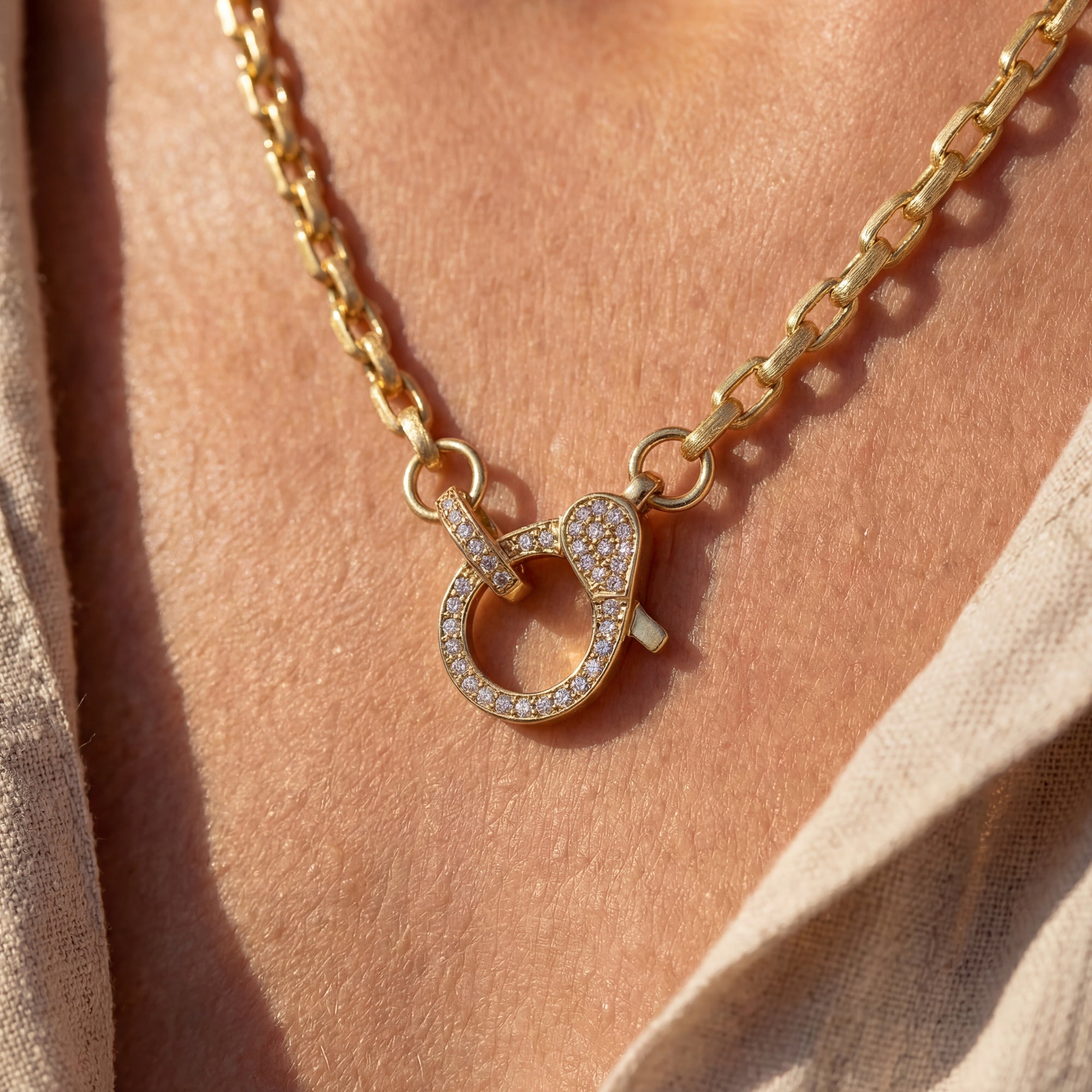 Gold necklace with a heart-shaped pendant on a person's neck