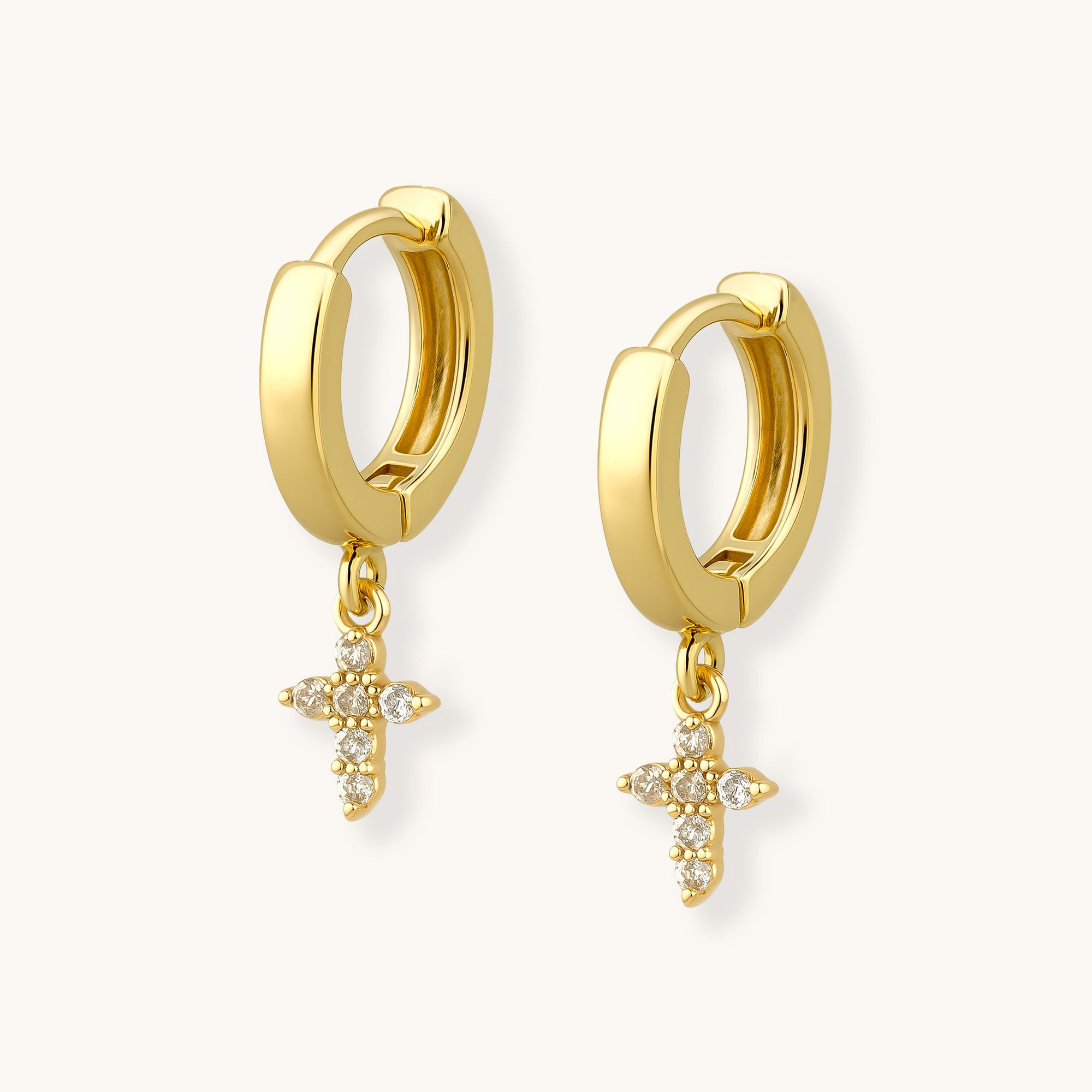 Gold hoop earrings with star-shaped charms on a white background