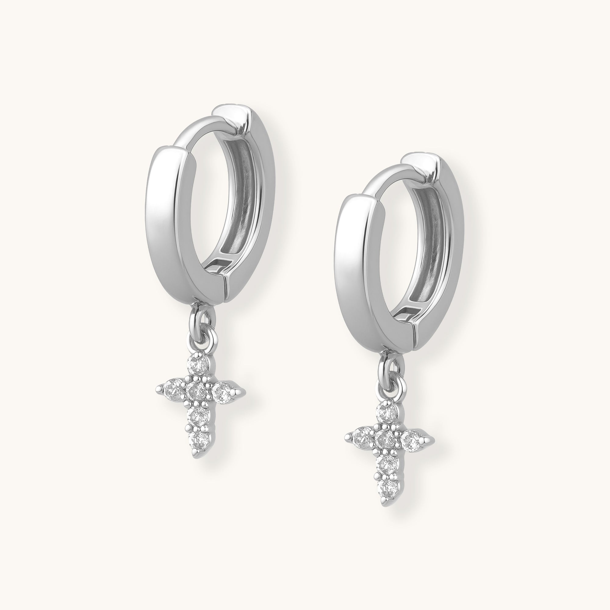 Silver hoop earrings with star-shaped charms on a white background