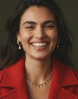 Woman wearing a red coat with a dark background