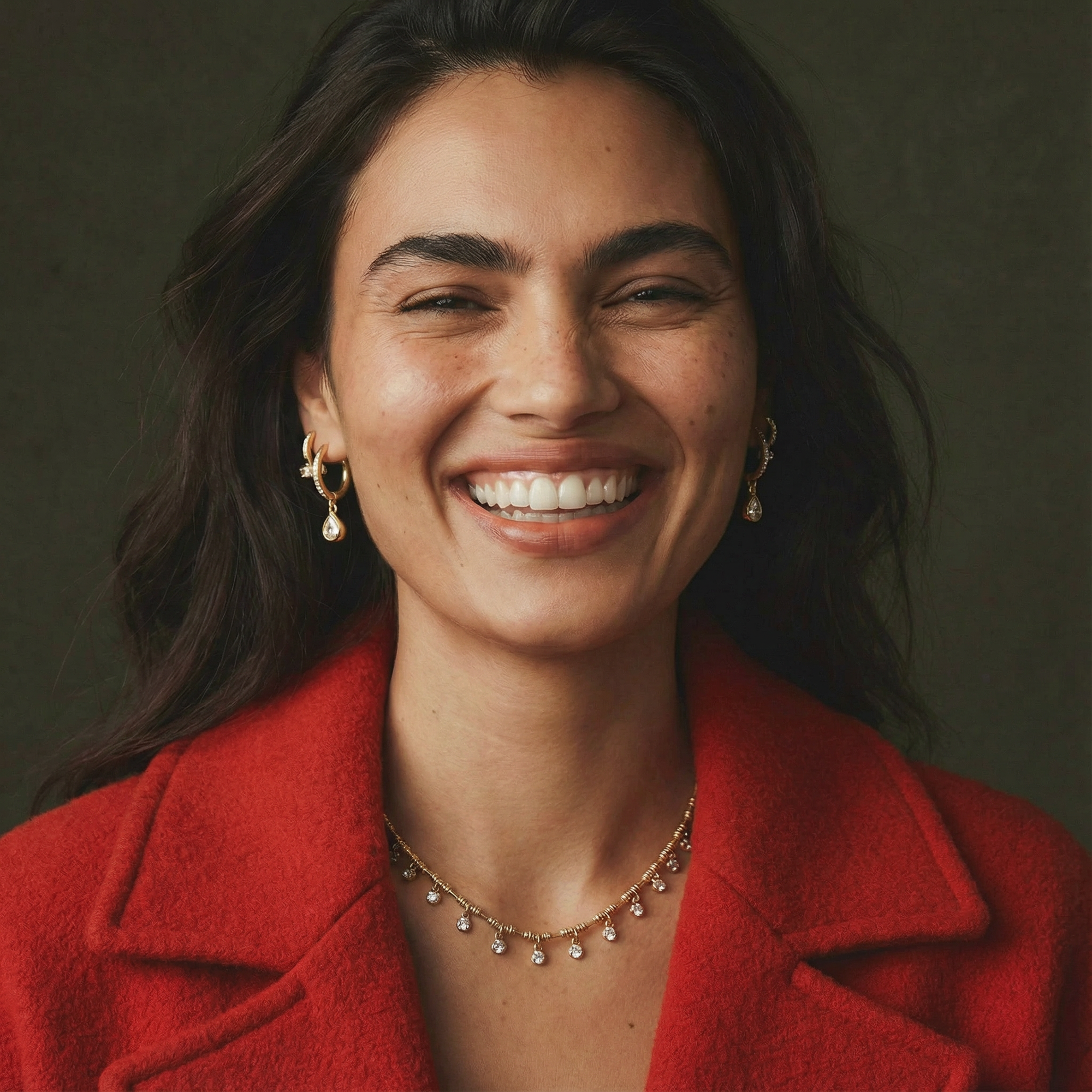 Woman wearing a red coat with a dark background