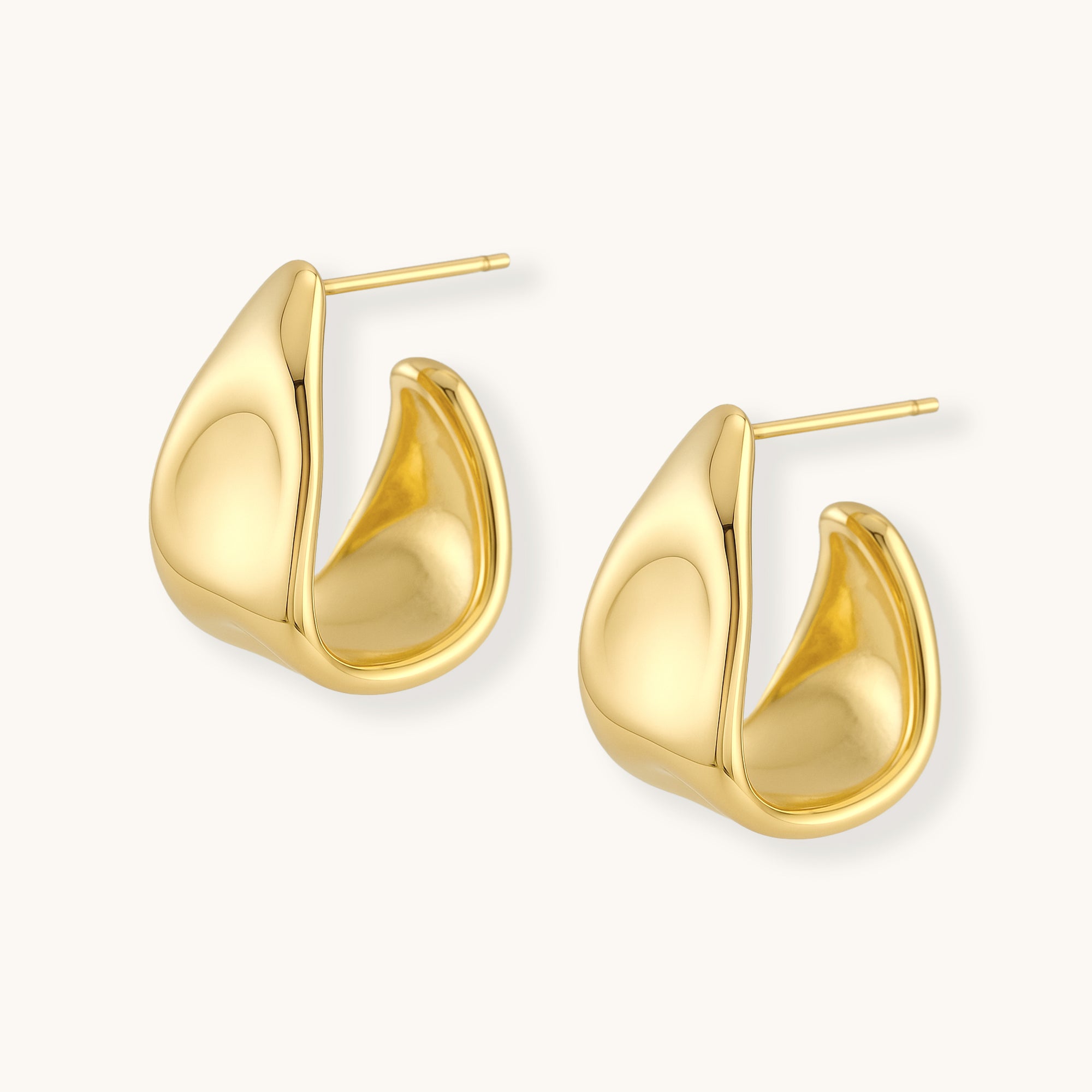 Gold hoop earrings on a white background