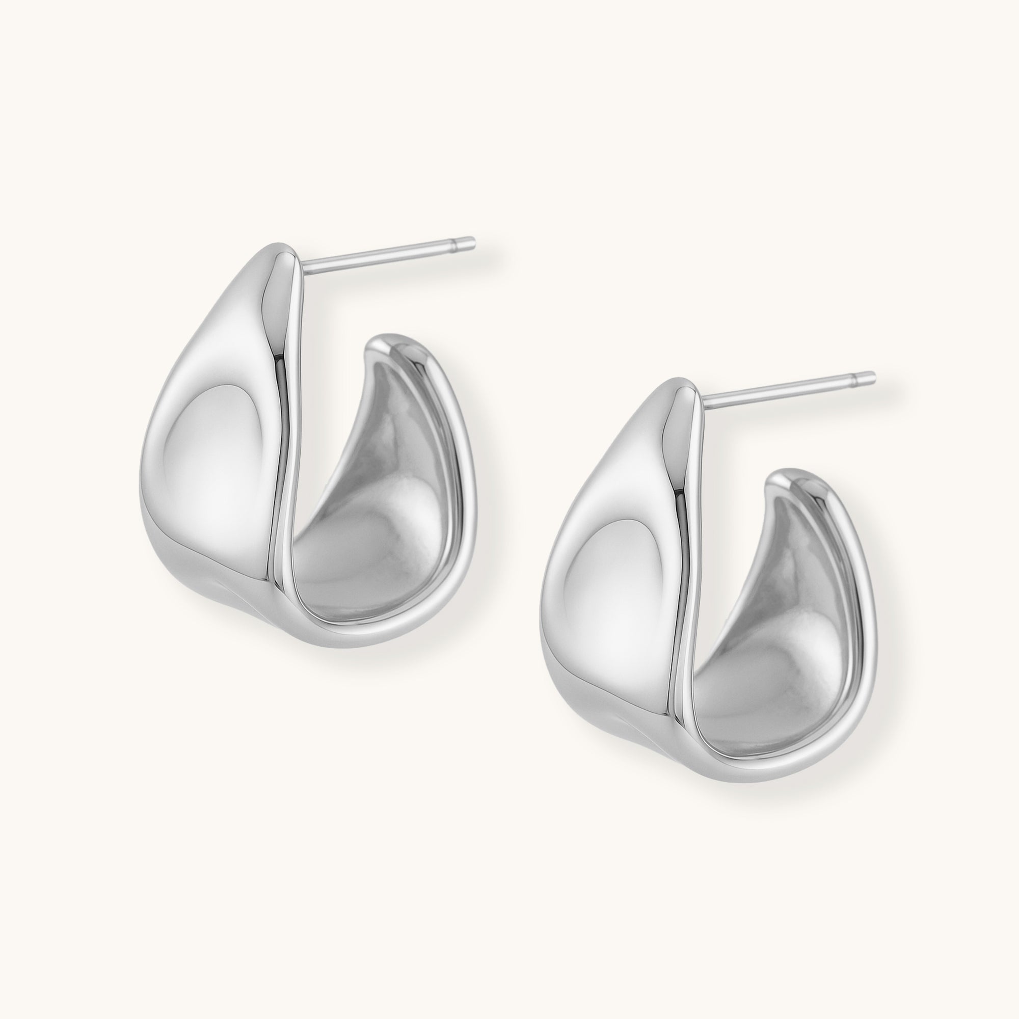 Pair of silver hoop earrings on a white background
