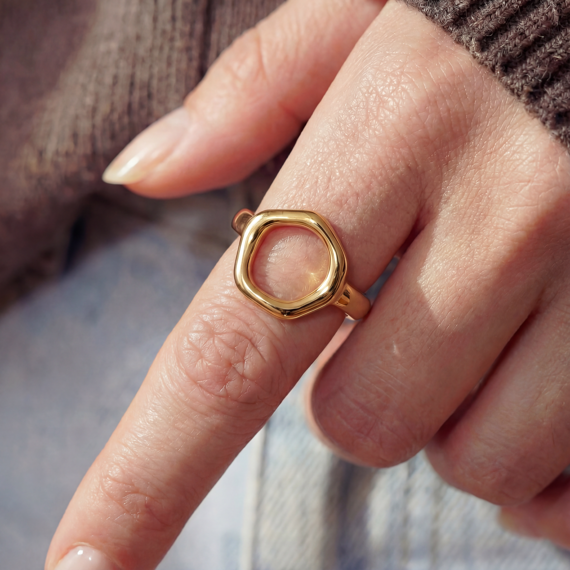 Gold ring on a finger with a blurred background