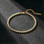 Gold bracelet with diamonds on a dark textured surface